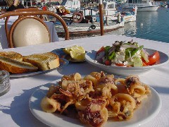 Kalamaraki and Greek salad, restaurants in Microlimino harbor Pireaus